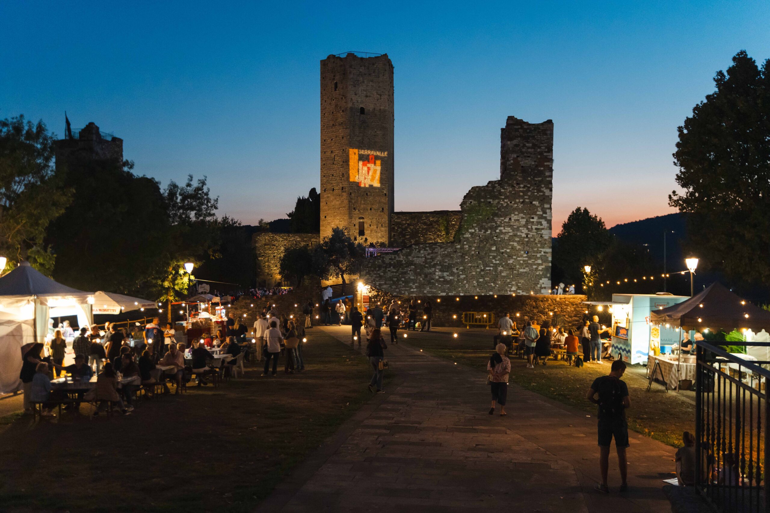 Veduta serale del palco illuminato alla Rocca di Castruccio durante un concerto del festival Serravalle Jazz a Serravalle Pistoiese.